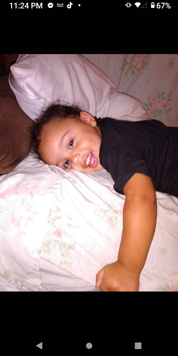 William is registered to the contest to win money with this photo: bed_sheet, bedding, bedtime, cheek, child, chin, comfort, eyebrow, flash_photography, forehead, fun, happy, linens, nap, nose, person, room, sitting, skin, smile