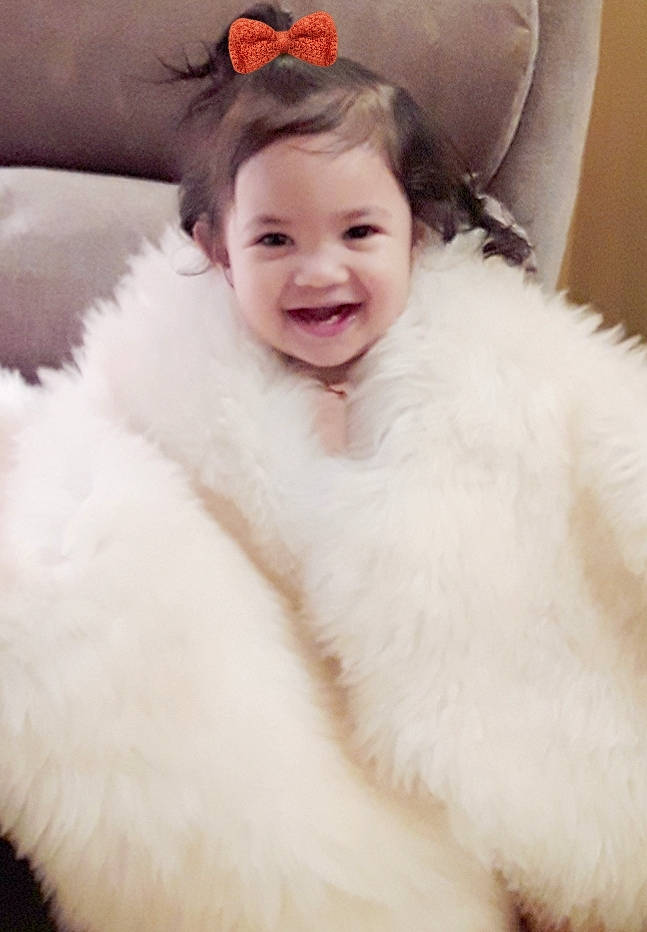 Summer is registered to the contest to win money with this photo: baby_toddler_clothing, dress, eye, eyebrow, eyelash, face, fashion_accessory, flash_photography, fun, fur_clothing, hair, happy, head, iris, jewellery, joy, lip, person, sleeve, smile