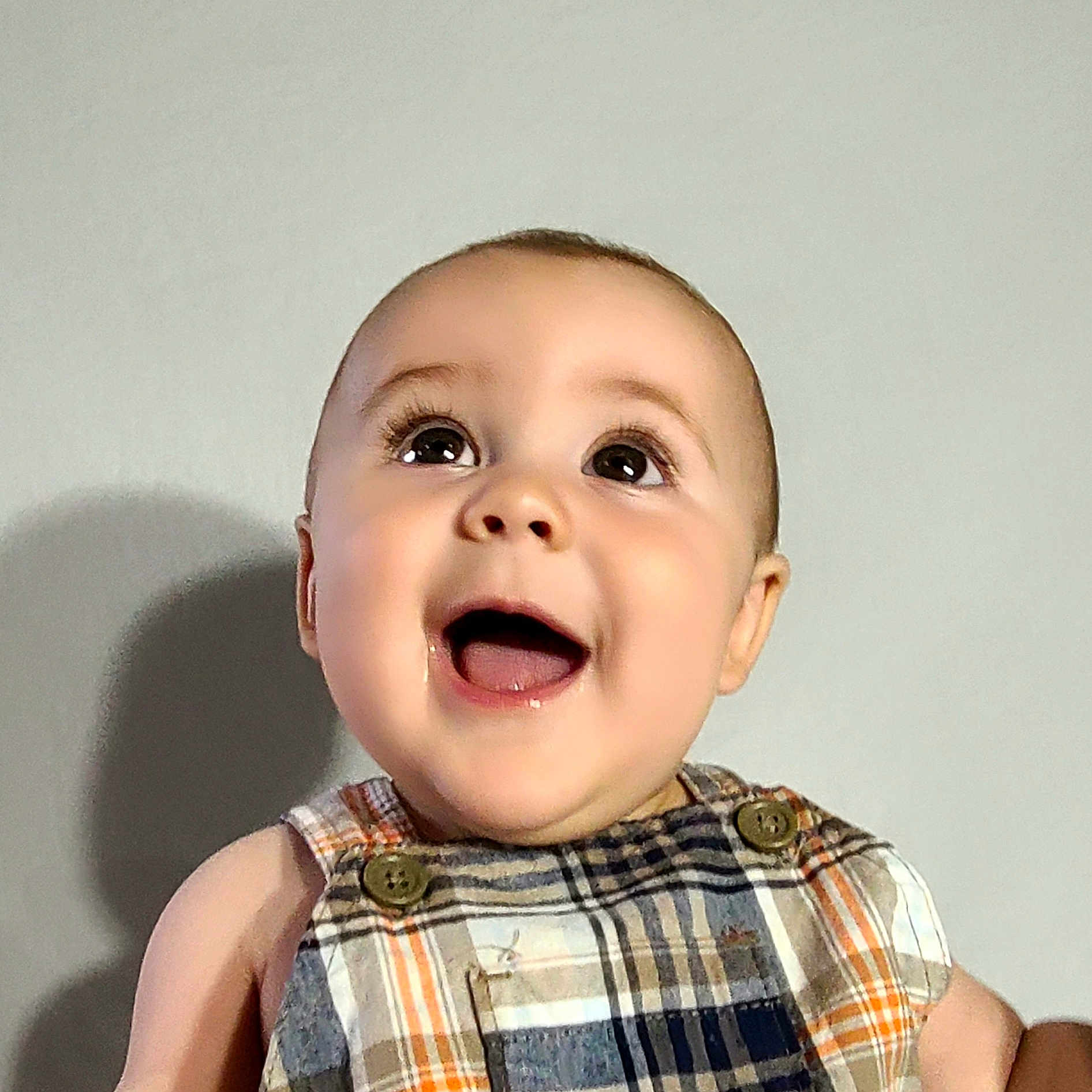 Emmett joined the competition — help win amazing prizes! baby, child, smiling, happy, plaid_clothing, cute, face, portrait, infant, eyes, mouth_open, skin, button, shadow, light, cheerful, closeup, expression, young, indoors