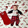 Emmett joined the competition — help win amazing prizes! baby, infant, santa_hat, christmas, holiday, stocking, ornaments, blanket, joy, red, black, plaid, cute, smiling, festive, lying_down, clothing, celebration, happy, indoors