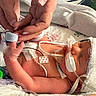 newborn, infant, baby, hospital, medical_equipment, incubator, hands, adult_hands, blanket,  의료, monitoring_wires, medical_tape, electrodes, tubing, pacifier, bassinet, premature_baby, resting, caregiving, close_up