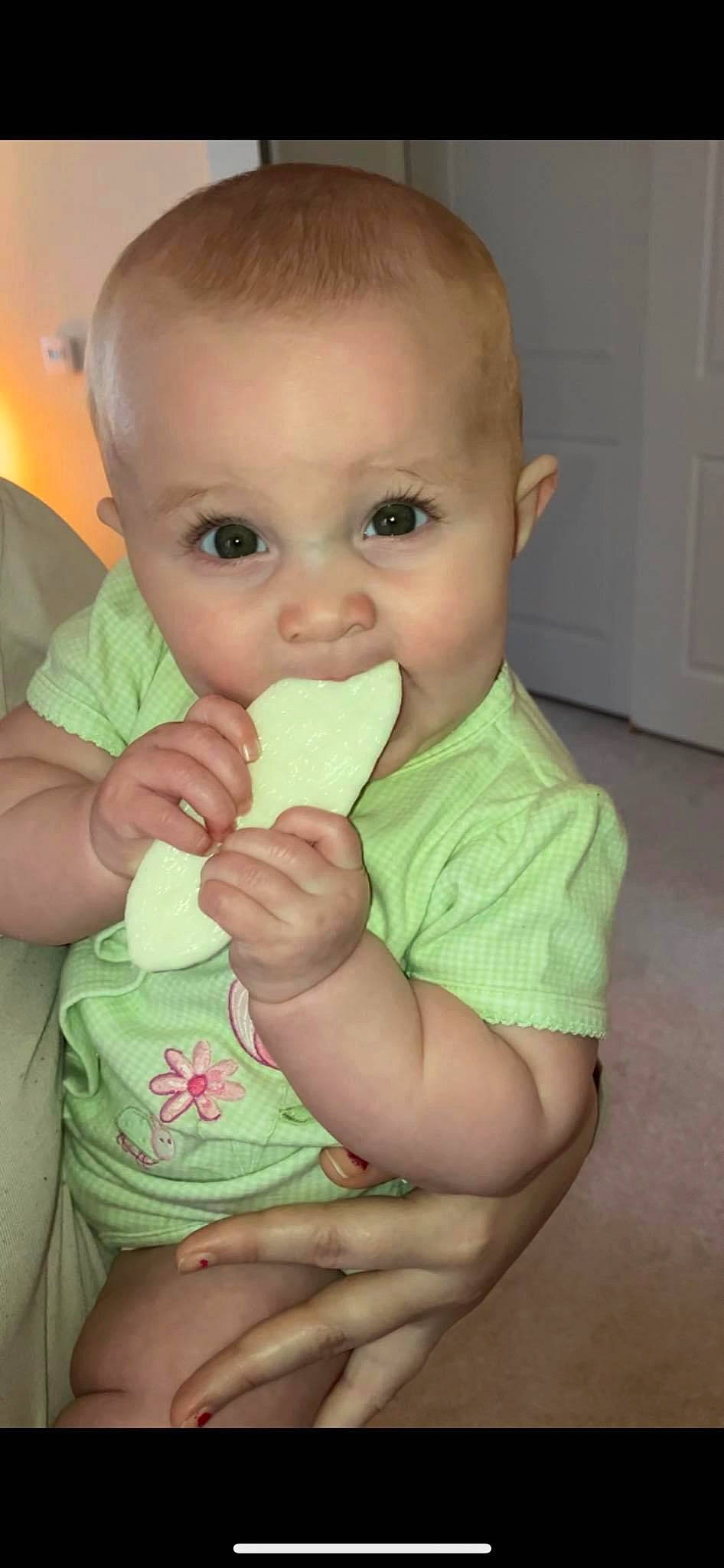 Meredith is registered to the contest to win money with this photo: arm, baby, baby_grabbing_for_something, baby_toddler_clothing, biting, cheek, eyelash, finger, gesture, hand, happy, iris, lip, mouth, nail, neck, nose, person, skin, thumb