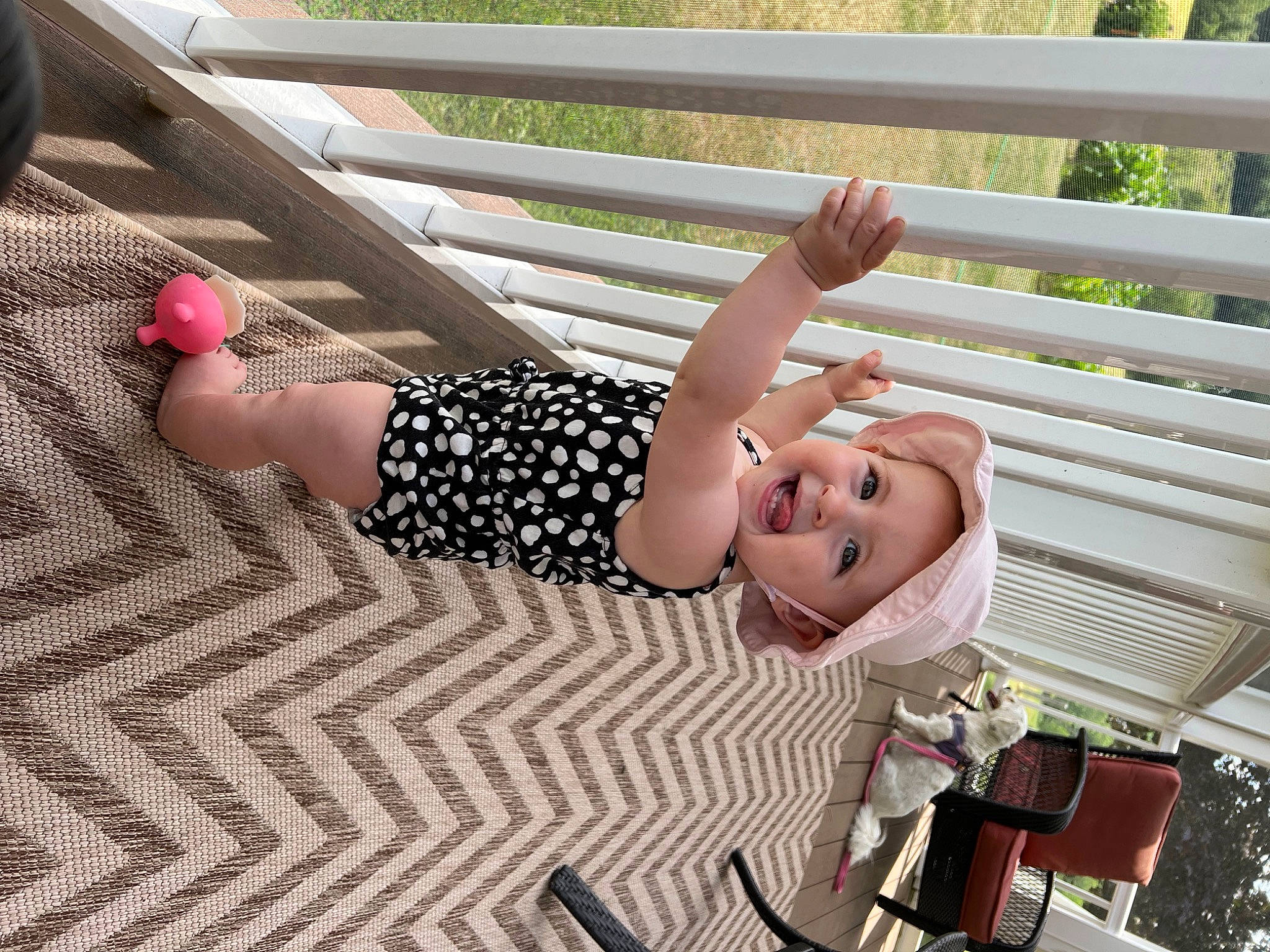 Adriana is registered to the contest to win money with this photo: blond, child, finger, flooring, foot, fun, grass, happy, headwear, human_leg, joint, knee, leisure, pattern, person, pink, smile, thigh, thumb, toddler