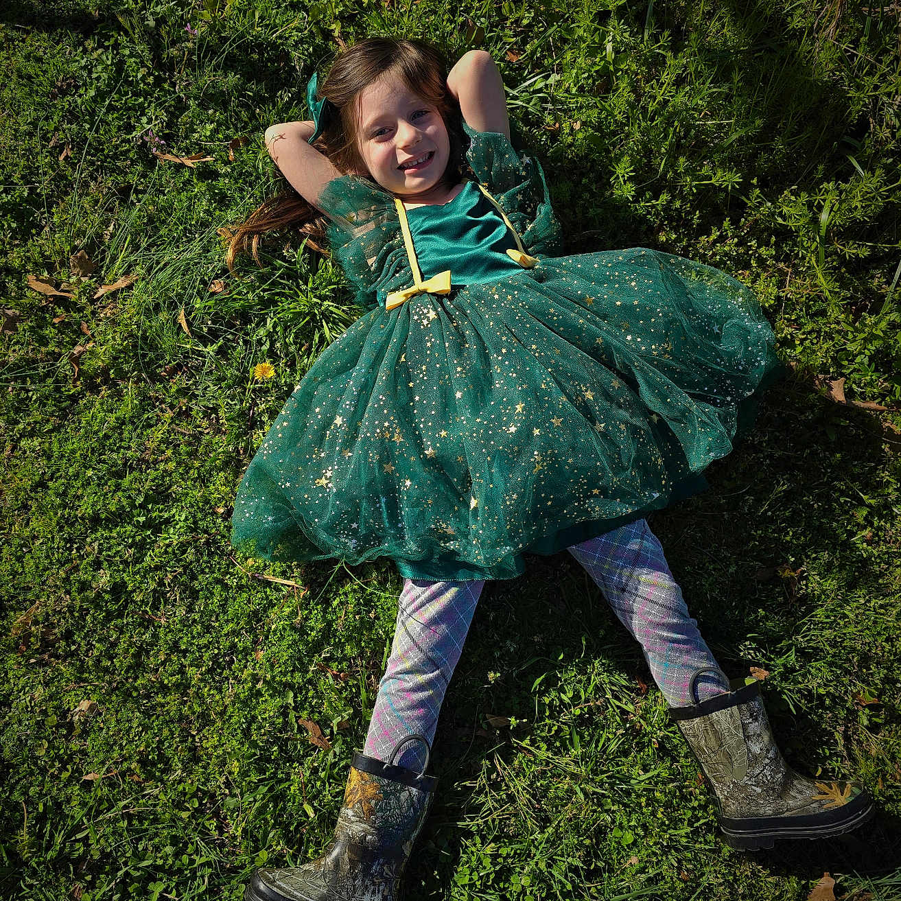Isabella is registered to the contest to win money with this photo: child, clothing, costume, dress, eveningdress, face, fashion, female, footwear, formalwear, girl, gown, grass, head, lawn, person, photography, plant, portrait, shoe