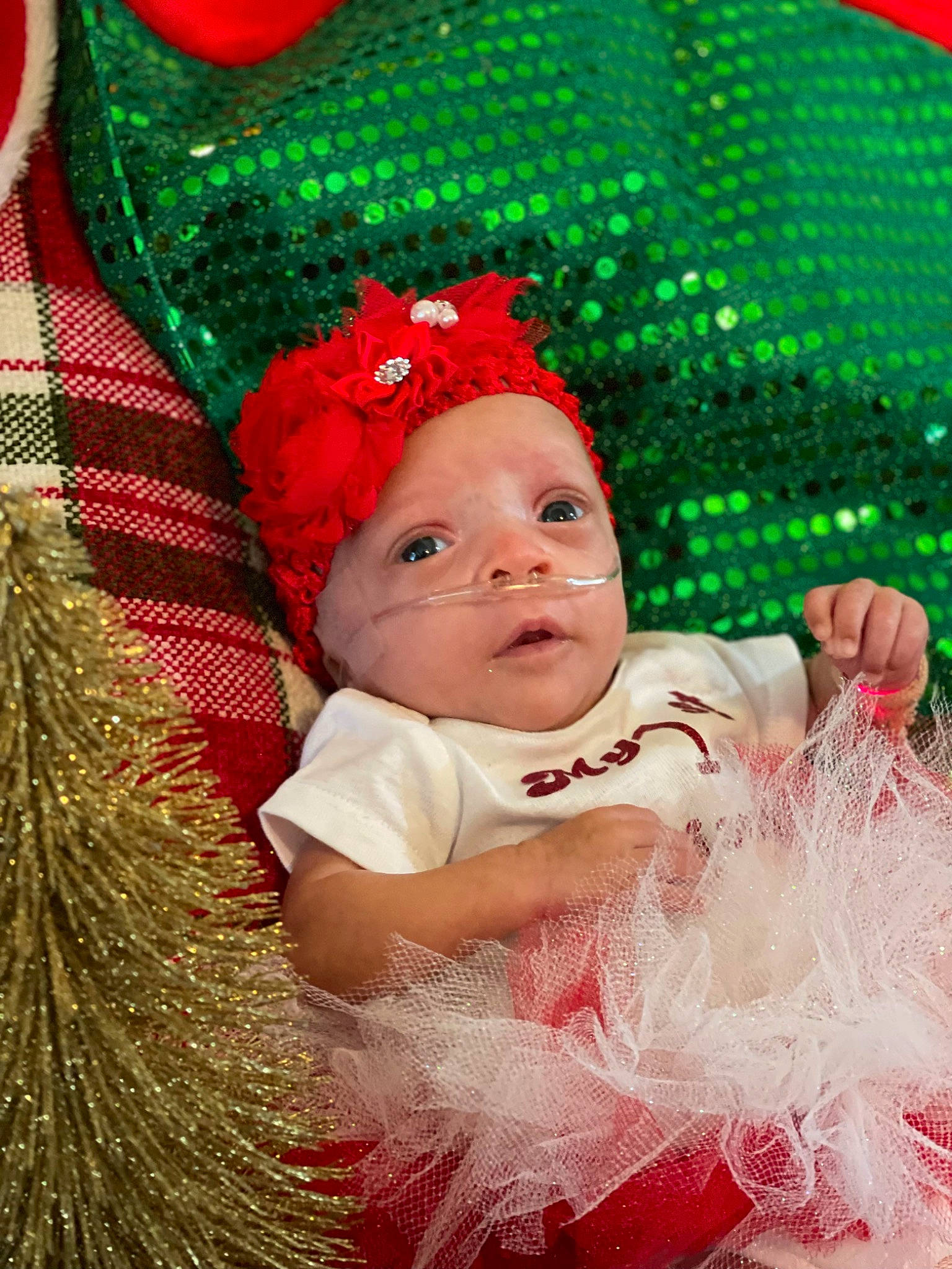 Aiyana is registered to the contest to win money with this photo: baby, baby_toddler_clothing, christmas, christmas_decoration, christmas_eve, christmas_ornament, costume_hat, fun, green, happy, hat, head, headgear, headwear, holiday, holiday_ornament, organ, person, pink, red