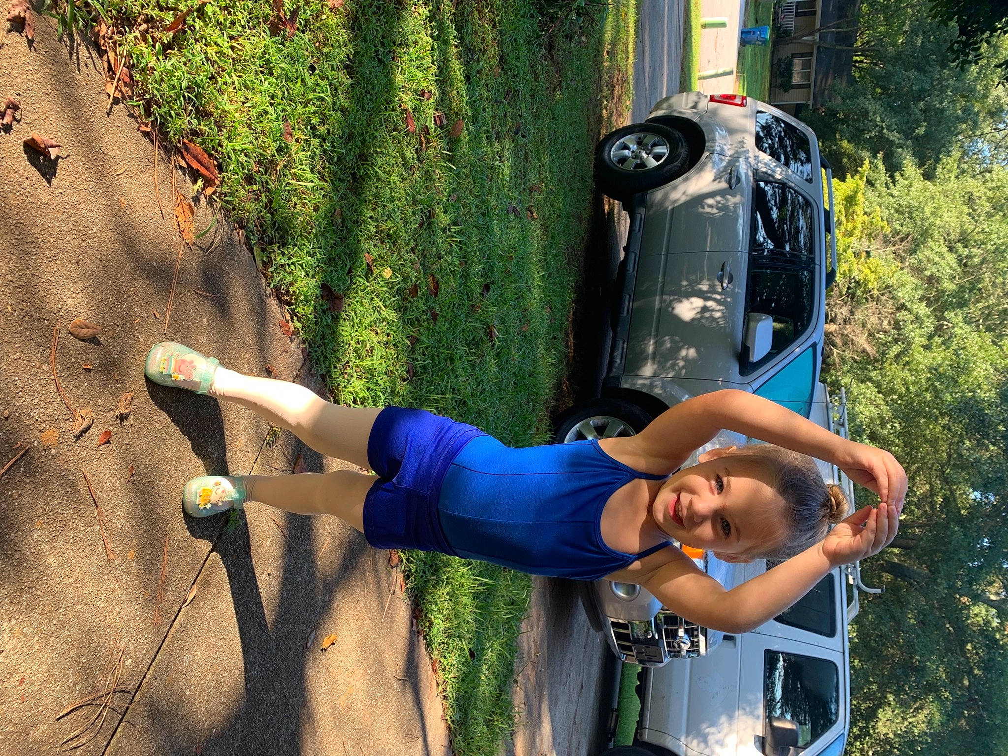 Ella is registered to the contest to win money with this photo: arm, automotive_design, automotive_exterior, automotive_lighting, car, grass, hand, hood, land_vehicle, leisure, light, motor_vehicle, people_in_nature, person, plant, smile, tire, vehicle, vehicle_door, wheel