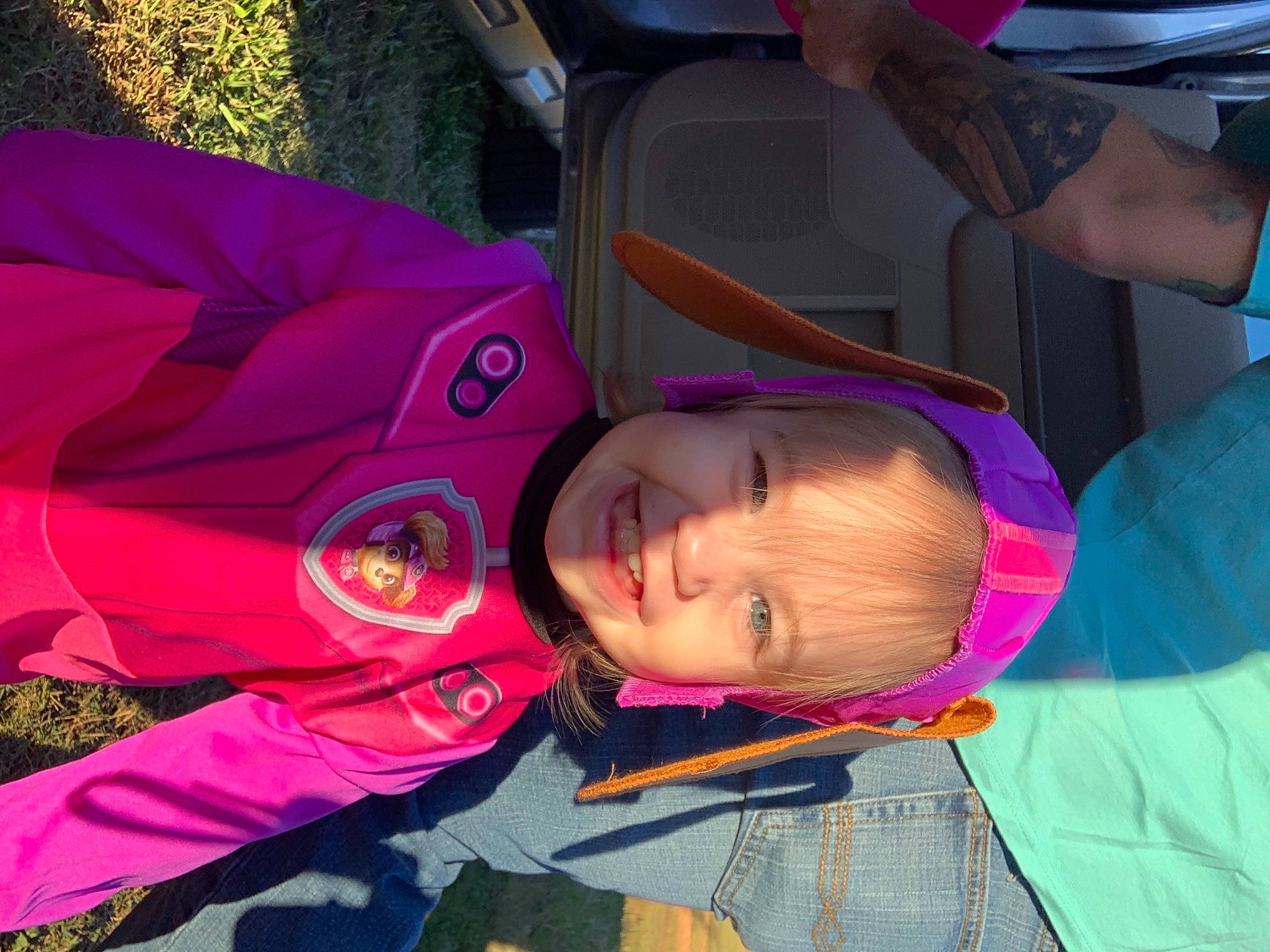 Emberly is registered to the contest to win money with this photo: baby, baby_products, carmine, child, fashion_accessory, fun, grass, leisure, magenta, organism, person, personal_protective_equipment, pink, plant, play, product, purple, recreation, t_shirt, toddler