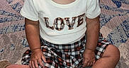 Gypsy joined the competition — help win amazing prizes! carpet, casual, child, clothing, curious, expression, face, floor, footwear, head, indoor, love_text, pattern, person, plaid_skirt, room, shirt, sitting, toddler, young