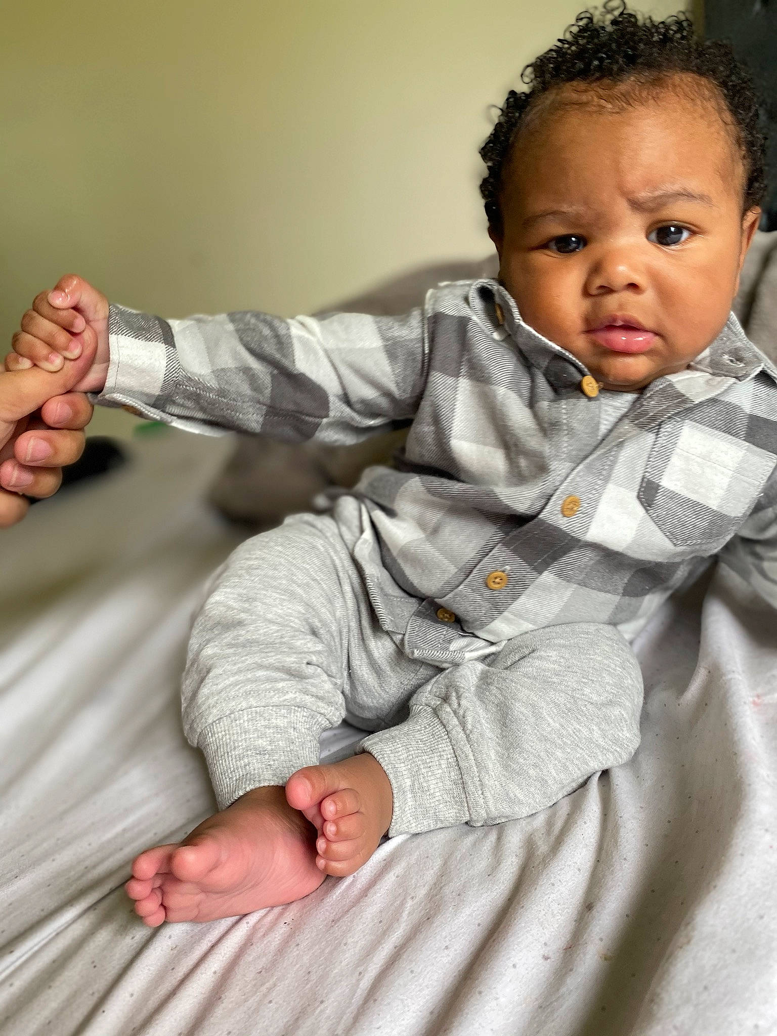 Harlem is registered to the contest to win money with this photo: arm, baby, cheek, child, comfort, finger, gesture, hand, person, sitting, skin, toddler