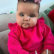 Ella a rejoint le concours — aidez-le/la à gagner de superbes lots ! baby, child, infant, pink_clothing, headband, flower_headband, toy, couch, indoor, portrait, cute, chubby_cheeks, hands, face, blue_eyes, curious, sitting, soft_texture, striped_couch, casual