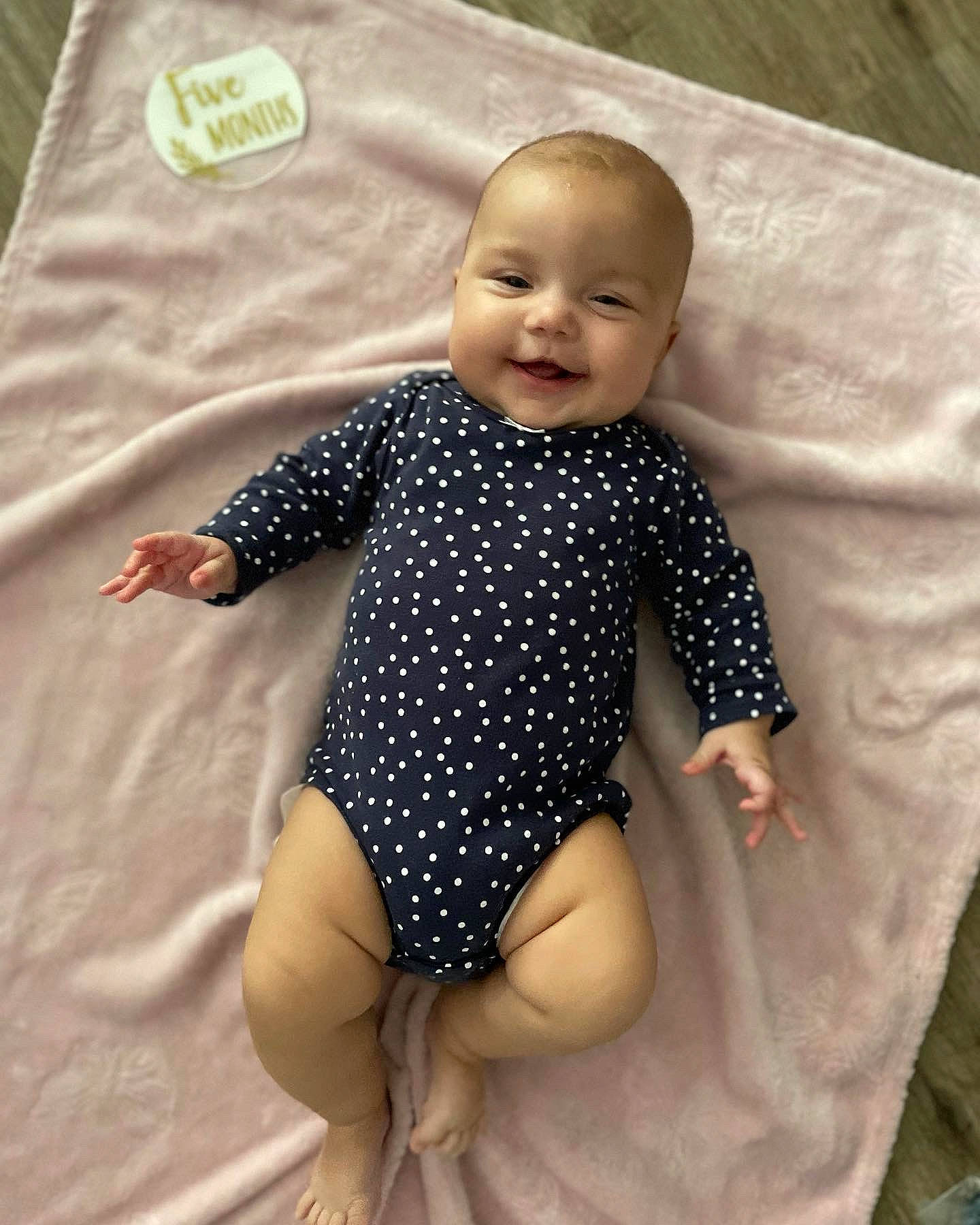 Eleanor is registered to the contest to win money with this photo: baby_toddler_clothing, barefoot, chest, eye, face, finger, happy, head, human_body, infant_bodysuit, joy, knee, leg, leotard, person, sleeve, smile, sportswear, thigh, toddler