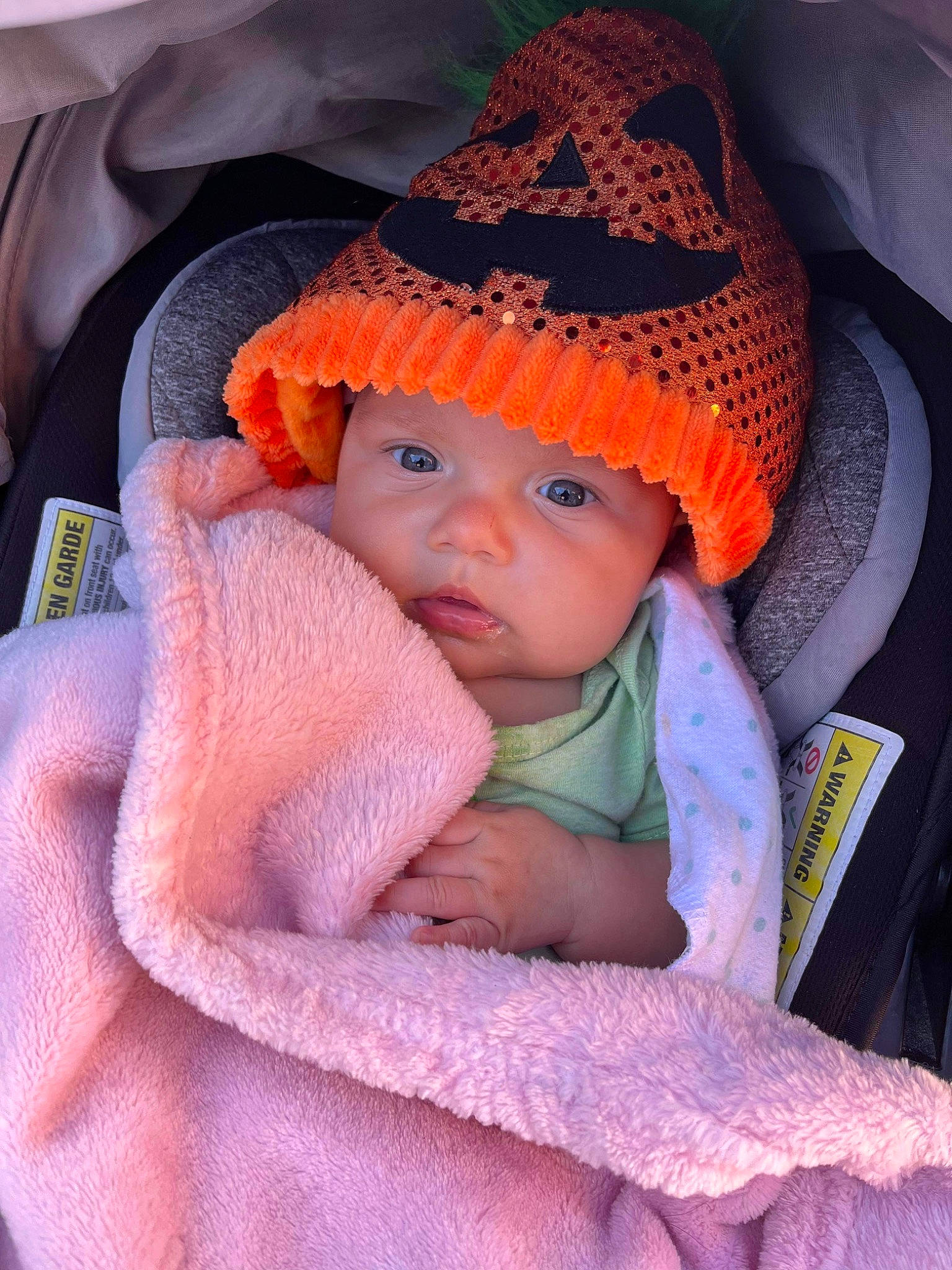 Eleanor is registered to the contest to win money with this photo: baby, baby_carriage, baby_products, baby_toddler_clothing, beanie, cap, cheek, child, comfort, electric_blue, fashion_accessory, headgear, headwear, knit_cap, magenta, person, pink, sitting, sleeve, toddler