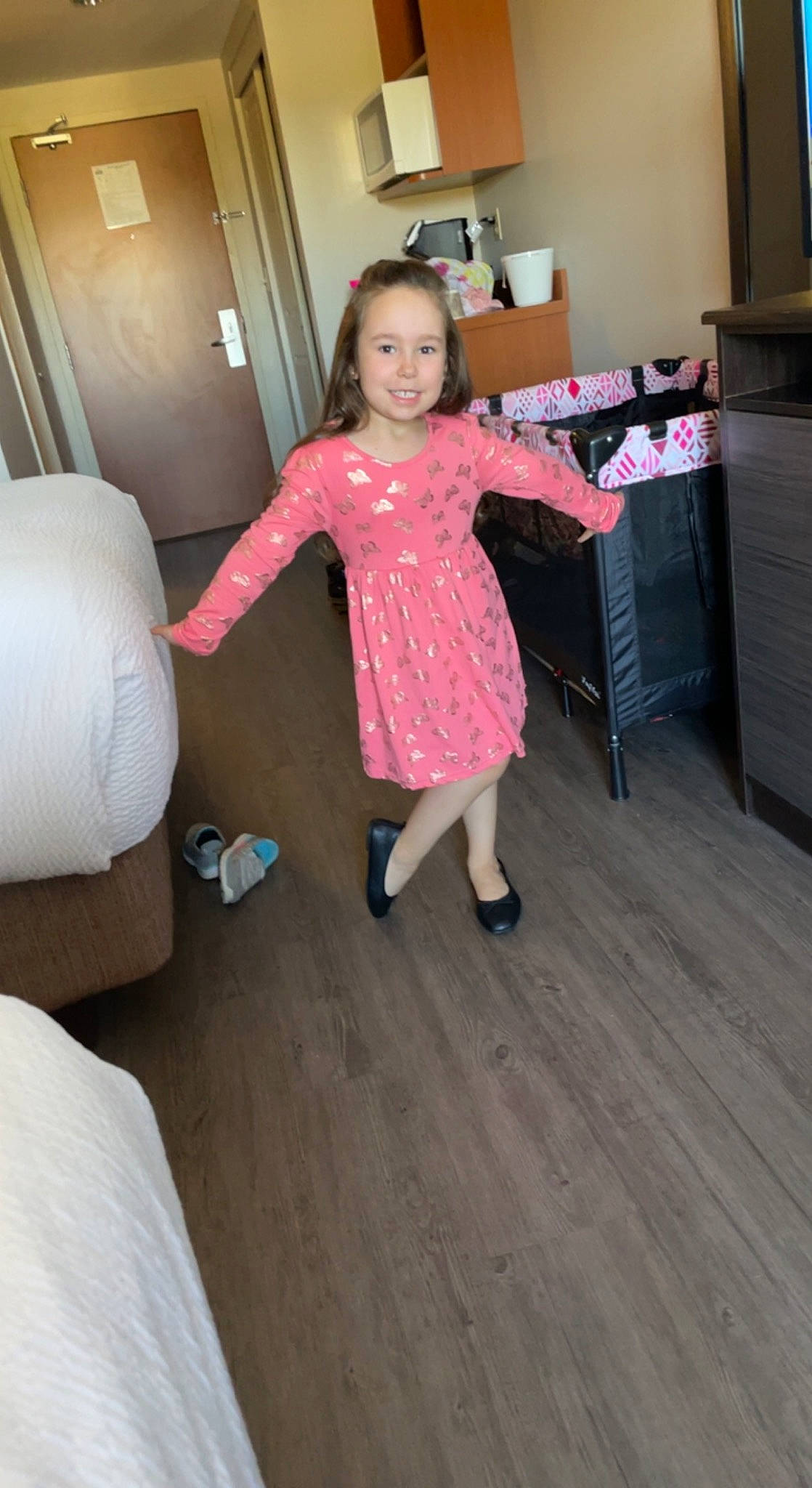 Talia-rose is registered to the contest to win money with this photo: cabinetry, chest_of_drawers, drawer, floor, flooring, foot, fun, happy, hardwood, house, human_leg, joy, knee, leg, living_room, person, sitting, smile, sock, toddler
