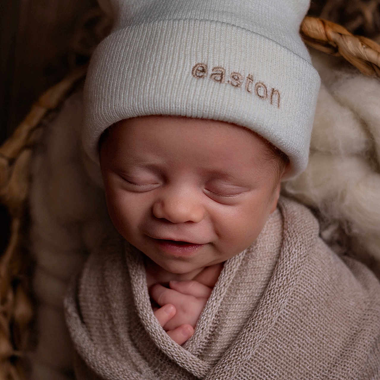 Easton is registered to the contest to win money with this photo: baby, basket, blanket, child, closeup, cozy, cute, face, hat, headwear, infant, newborn, peaceful, portrait, resting, sleeping, smile, soft, wool, wrapped