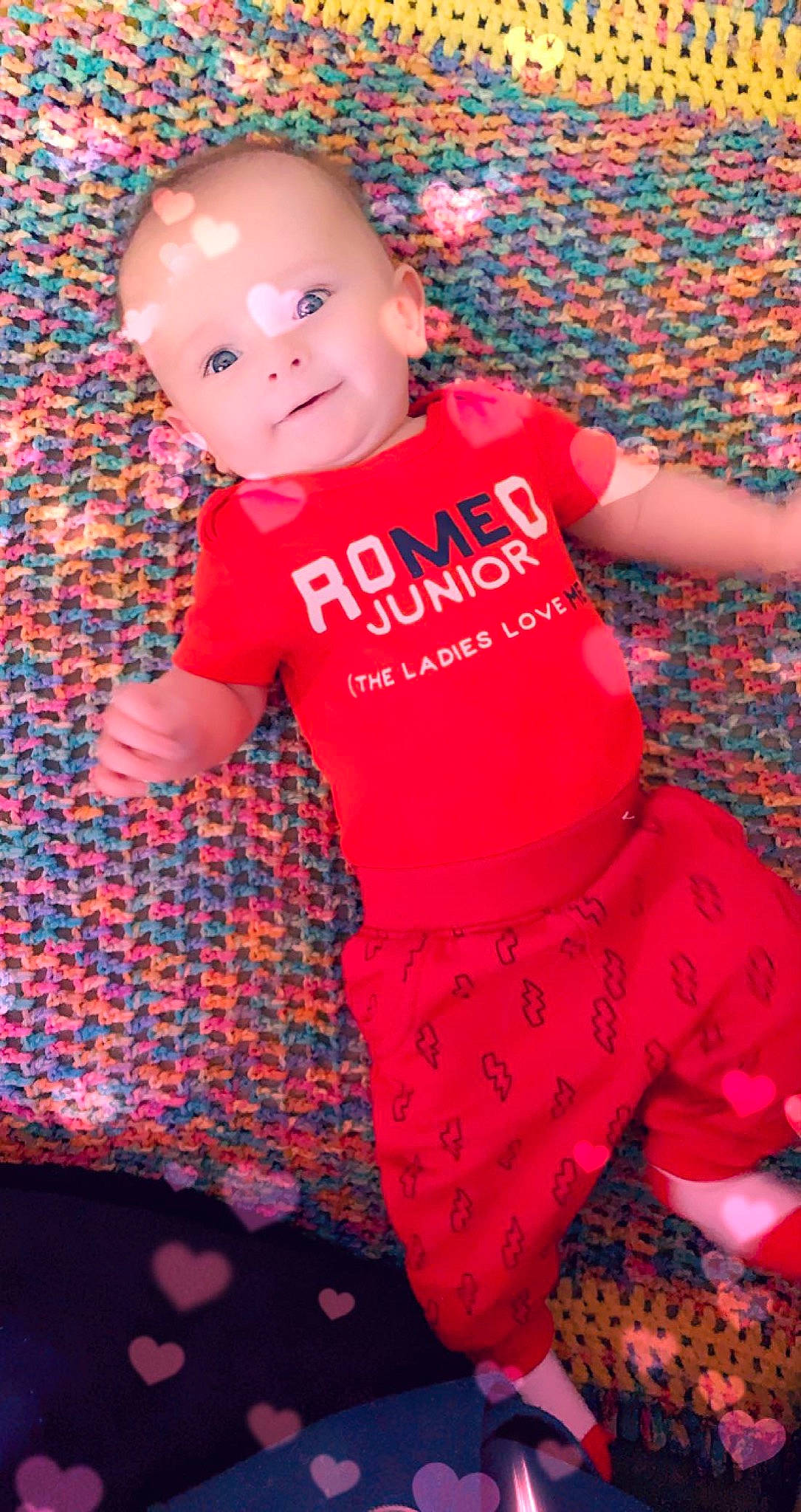 Hades joined the competition — help win amazing prizes! baby, baby_toddler_clothing, fun, happy, head, human_body, magenta, orange, pattern, person, pink, purple, red, skin, sleeve, smile, t_shirt, textile, thigh, toddler