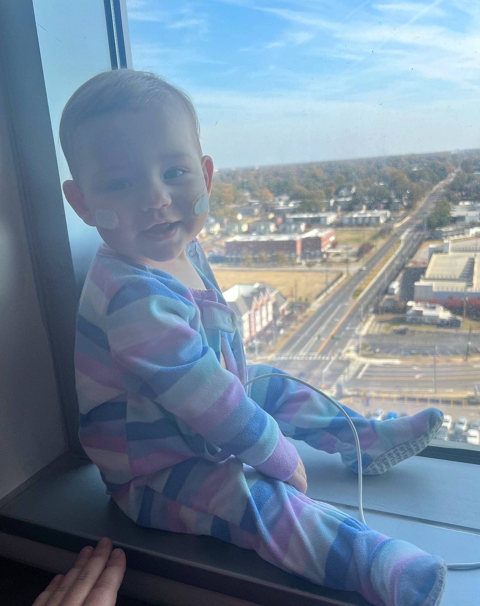 Kimber is registered to the contest to win money with this photo: baby, child, city, cloud, cool, eye, finger, flooring, fun, hand, happy, horizon, landscape, leisure, person, sitting, sky, thumb, toddler, travel