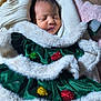 baby, newborn, sleeping, face, fur_trim, green_velvet, festive_clothing, soft_blanket, wrapped, cute, infant, cozy, holiday_outfit, child, portrait, indoors, peaceful, tiny, adorable, warm