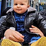 baby, blue_shirt, casual_clothing, child, curtains, cute, face, hands, indoor, jeans, leather_jacket, person, portrait, reflection, smile, table, toddler, window, wood, yellow_boots