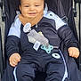 Adam participe au concours pour gagner de l'argent avec cette photo : baby, bib, black, child, clothing, comfort, curly_hair, cute, face, hand, infant, jacket, outdoor, pacifier, pants, relax, smile, socks, stroller, white