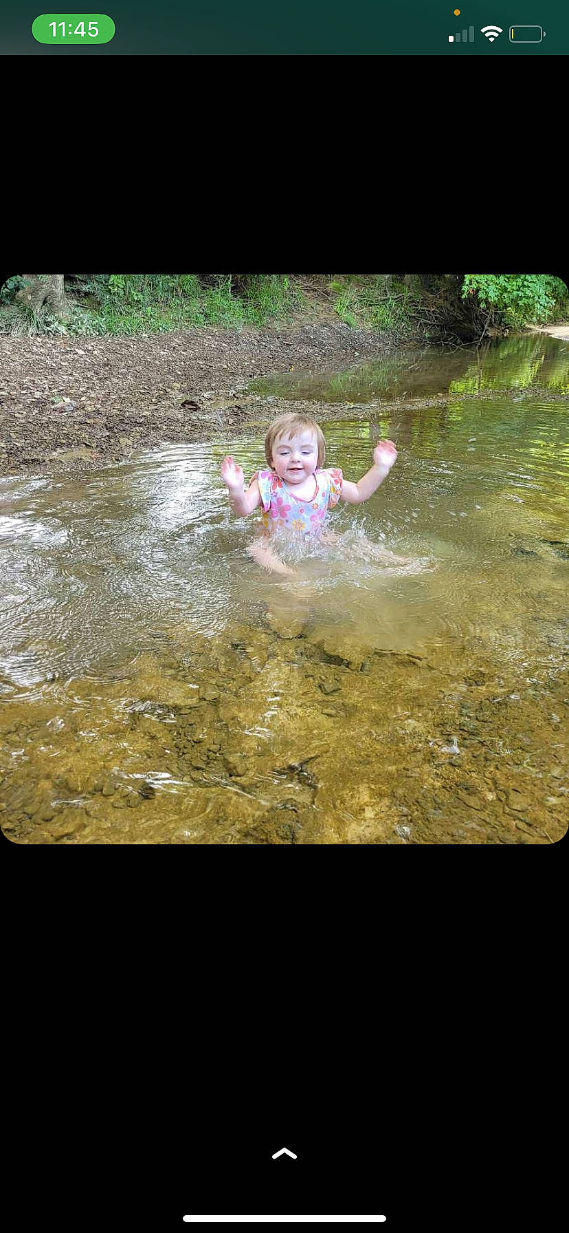 Emberlyn is registered to the contest to win money with this photo: asphalt, bathing, fun, grass, happy, joy, landscape, leisure, people_in_nature, person, play, pond, puddle, recreation, reflection, rock, smile, soil, stream, toddler