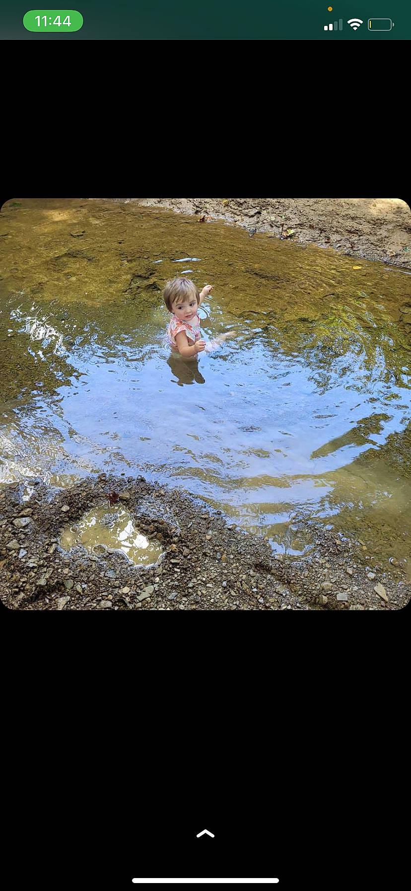 Emberlyn is registered to the contest to win money with this photo: asphalt, bathing, fun, grass, landscape, leisure, people_in_nature, person, pond, puddle, recreation, rectangle, reflection, road_surface, rock, soil, stream, toddler, water, water_resources