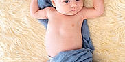 Maverick joined the competition — help win amazing prizes! baby, bare_chest, blanket, blue_cloth, child, comfort, curious_expression, cute, fluffy_rug, indoors, infant, lying_down, newborn, portrait, raised_arms, resting, skin, sleeping_area, soft_texture, toddler
