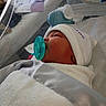 Angel is registered to the contest to win money with this photo: newborn, baby, pacifier, blanket, hospital, bassinet, sleeping, infant, hat, medical, bed, towel, cozy, patient, child, resting, portrait, cute, indoors, person