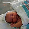 Angel is registered to the contest to win money with this photo: newborn, baby, sleeping, infant, blanket, hospital, bassinet, hat, peaceful, wrapped, skin, closed_eyes, newborn_baby, cute, resting, child, person, indoors, portrait, towel