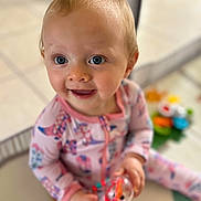 Blakelynn Grace joined the competition — help win amazing prizes! baby, child, playing, toy, onesie, pink_clothing, blue_eyes, smiling, indoor, floor, playmat, cute, happy, infant, person, portrait, sitting, hand, face, young