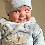 Leland is registered to the contest to win money with this photo: baby, infant, smile, hat, cute, soft_clothing, fuzzy, bear_design, cheeks, portrait, child, happy, indoors, face, young, adorable, warm_clothing, headwear, expression, closeup