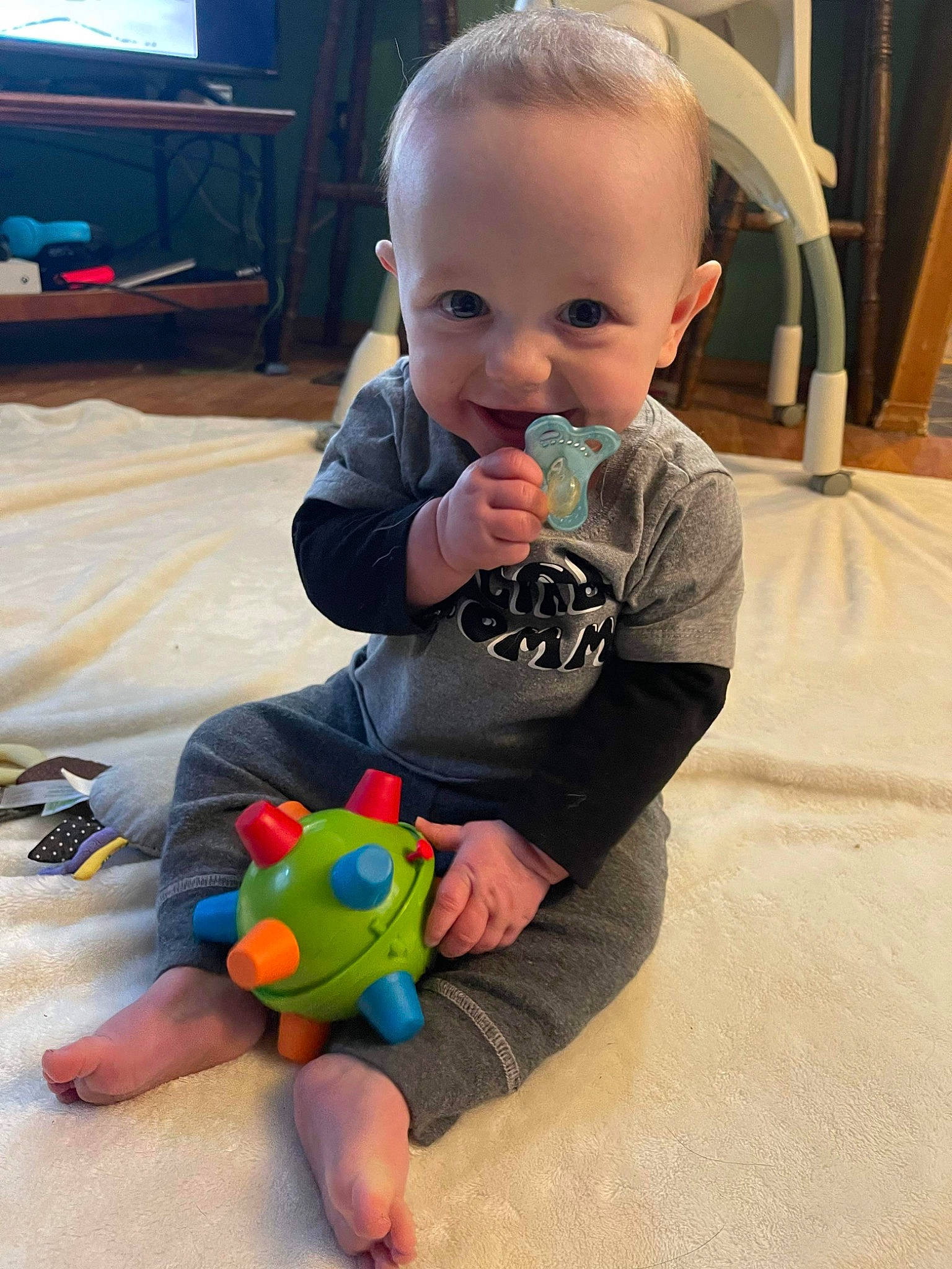 Deegan joined the competition — help win amazing prizes! arm, baby, baby_playing_with_toys, baby_toddler_clothing, cheek, child, finger, floor, flooring, fun, hand, head, joy, person, room, sitting, skin, smile, snapshot, television