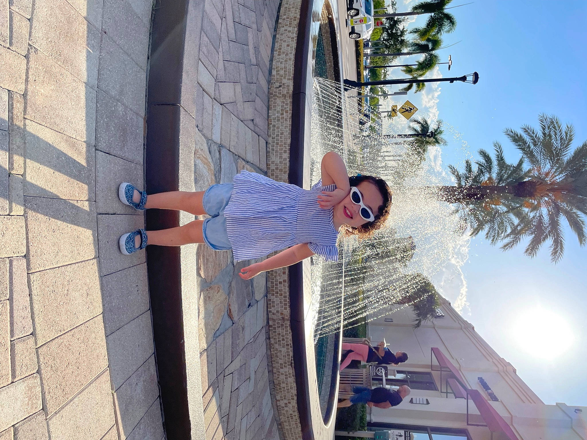 Rachel is registered to the contest to win money with this photo: arecales, azure, blue, building, daytime, electric_blue, event, facade, fun, joy, leisure, light, line, palm_tree, person, plant, sky, smile, stairs, travel