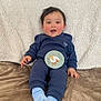 Akira participe au concours pour gagner de l'argent avec cette photo : baby, infant, smiling, blue_clothing, socks, blanket, milestone_card, face, person, cute, happy, indoor, child, sitting, soft_texture, young, portrait, cozy, skin, hands
