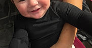 Kamila joined the competition — help win amazing prizes! adult_hand, arm, baby, black_shirt, child, closeup, clothing, cute, face, happy, headband, holding, human, indoor, person, portrait, reaching_hand, sitting, smile, white_pants