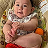 Kamila joined the competition — help win amazing prizes! baby, child, infant, headband, foot, hand, cushion, seat, clothing, red_shorts, white_bib, patterned_bib, smiling, cute, indoors, skin, person, playful, toy, comfort
