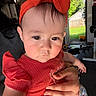 baby, child, headband, red_clothing, ruffled_sleeve, hand, tattoo, indoor, door, backyard, grass, window, toy, person, face, expressionless, closeup, holding, casual, natural_light