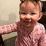 toddler, child, smiling, face, headband, bow, pajamas, pink, patterned_clothing, indoor, person, cute, happy, young_child, baby, sitting, portrait, head, clothing, infant