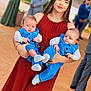 Marli Lima Tedesco participe au concours pour gagner de l'argent avec cette photo : woman, baby, twins, blue_suit, dress, outdoor, event, formal_wear, holding, smile, people, portrait, group, blurred_background, child, young_adult, footwear, happy, family, celebration