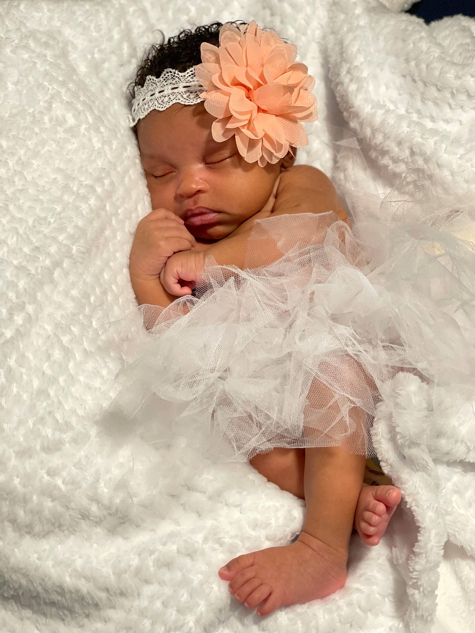 Kamaya is registered to the contest to win money with this photo: baby, baby_toddler_clothing, bridal_accessory, comfort, dress, embellishment, finger, flash_photography, flower, gesture, hand, happy, headgear, headpiece, headwear, leg, person, petal, pink, skin