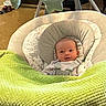 baby, blanket, infant, baby_seat, green, soft_toys, face, indoors, child, cushion, newborn, cute, smile, cozy, fabric, toddler, head, comfort, resting, floor