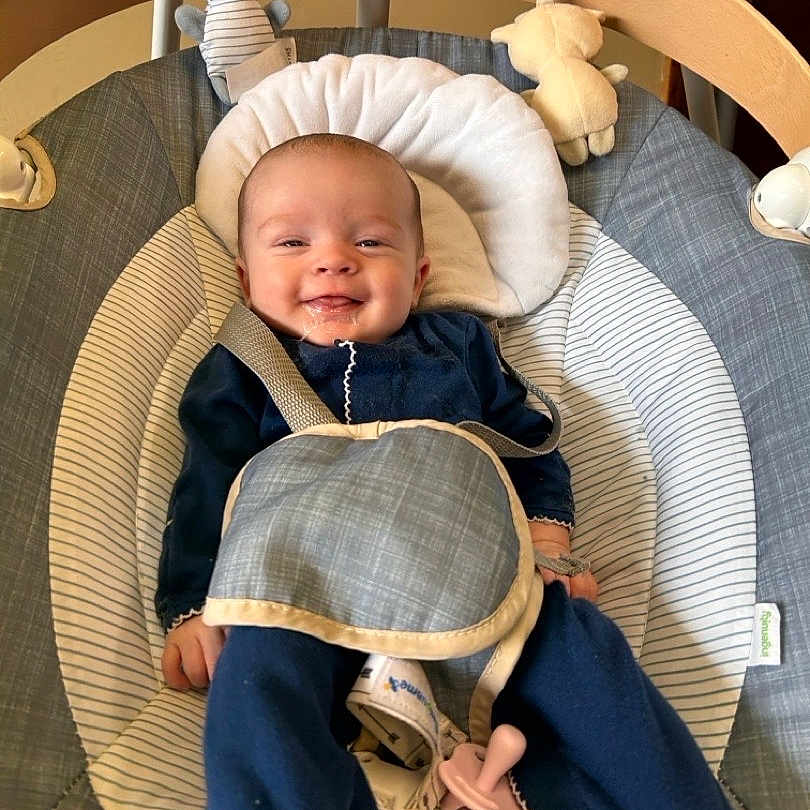 Madelyn joined the competition — help win amazing prizes! baby, smiling, infant, baby_rocker, toy, plush_toy, clothing, straps, face, happy, child, indoor, seat, fabric, comfort, cute, person, newborn, blue_clothing, soft_toys
