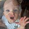 Lucas joined the competition — help win amazing prizes! baby, child, face, hand, glass, reflection, curious, cute, expression, indoor, person, white_shirt, short_sleeve, skin, eyes, nose, mouth, tongue, adult