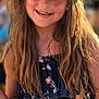 child, girl, smiling, hat, straw_hat, long_hair, floral_dress, outdoor, sunlight, portrait, happy, fashion, summer, casual_clothing, face, person, cute, natural_light, closeup, young