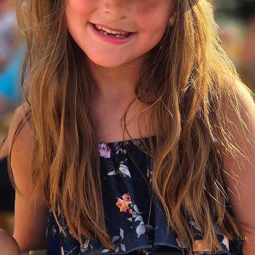 Charlotte participe au concours pour gagner de l'argent avec cette photo : casual_clothing, child, closeup, cute, face, fashion, floral_dress, girl, happy, hat, long_hair, natural_light, outdoor, person, portrait, smiling, straw_hat, summer, sunlight, young