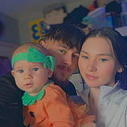 Leia is registered to the contest to win money with this photo: baby, child, couple, family, portrait, indoor, costume, headband, orange, green, toddler, smile, love, people, young, cute, holding, happy, face, together