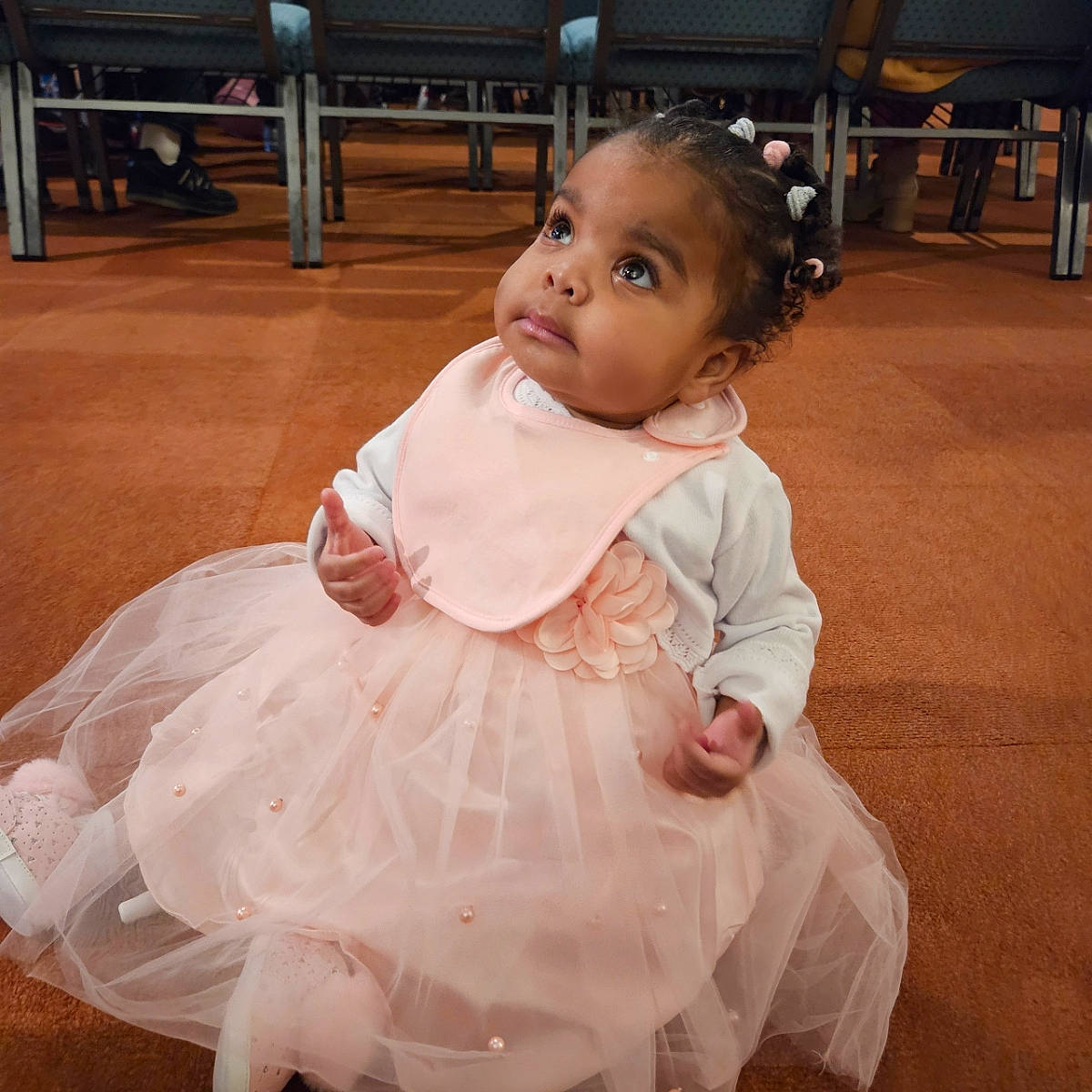 Jazmine is registered to the contest to win money with this photo: baby, baby_toddler_clothing, chair, day_dress, dress, embellishment, event, flooring, fun, hair, happy, head, iris, person, pink, ruffle, skin, sleeve, smile, standing