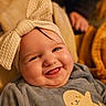 baby, smiling, headwrap, cute, child, infant, clothing, portrait, happy, cozy, soft, yellow, grey, animal_print, seal, indoor, warm_lighting, cheeks, tongue, person