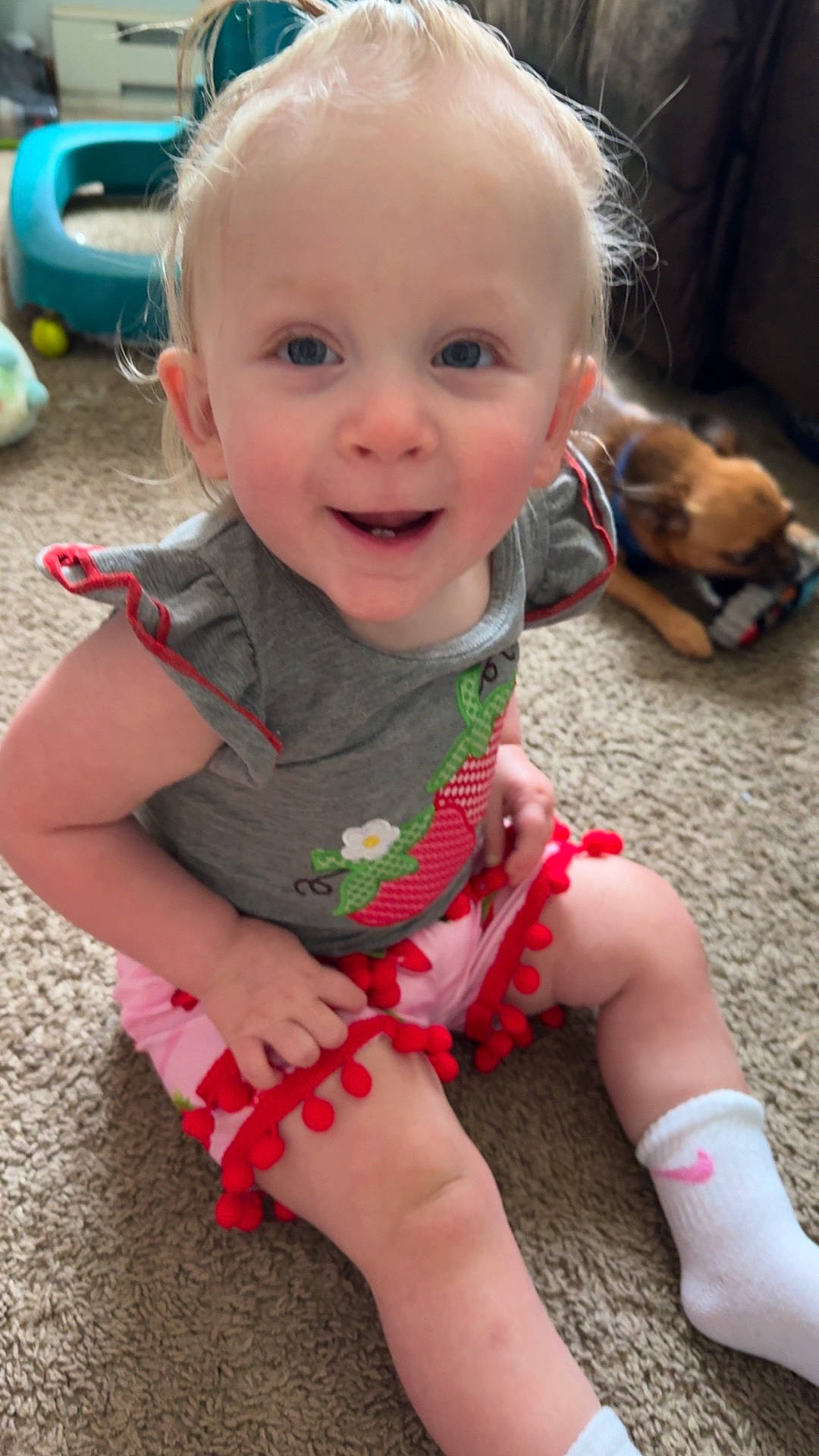 Cora is registered to the contest to win money with this photo: baby, bodypart, clothing, costume, dress, face, finger, hand, happy, head, hosiery, indoors, mouth, person, photography, portrait, shorts, sitting, smile, sock