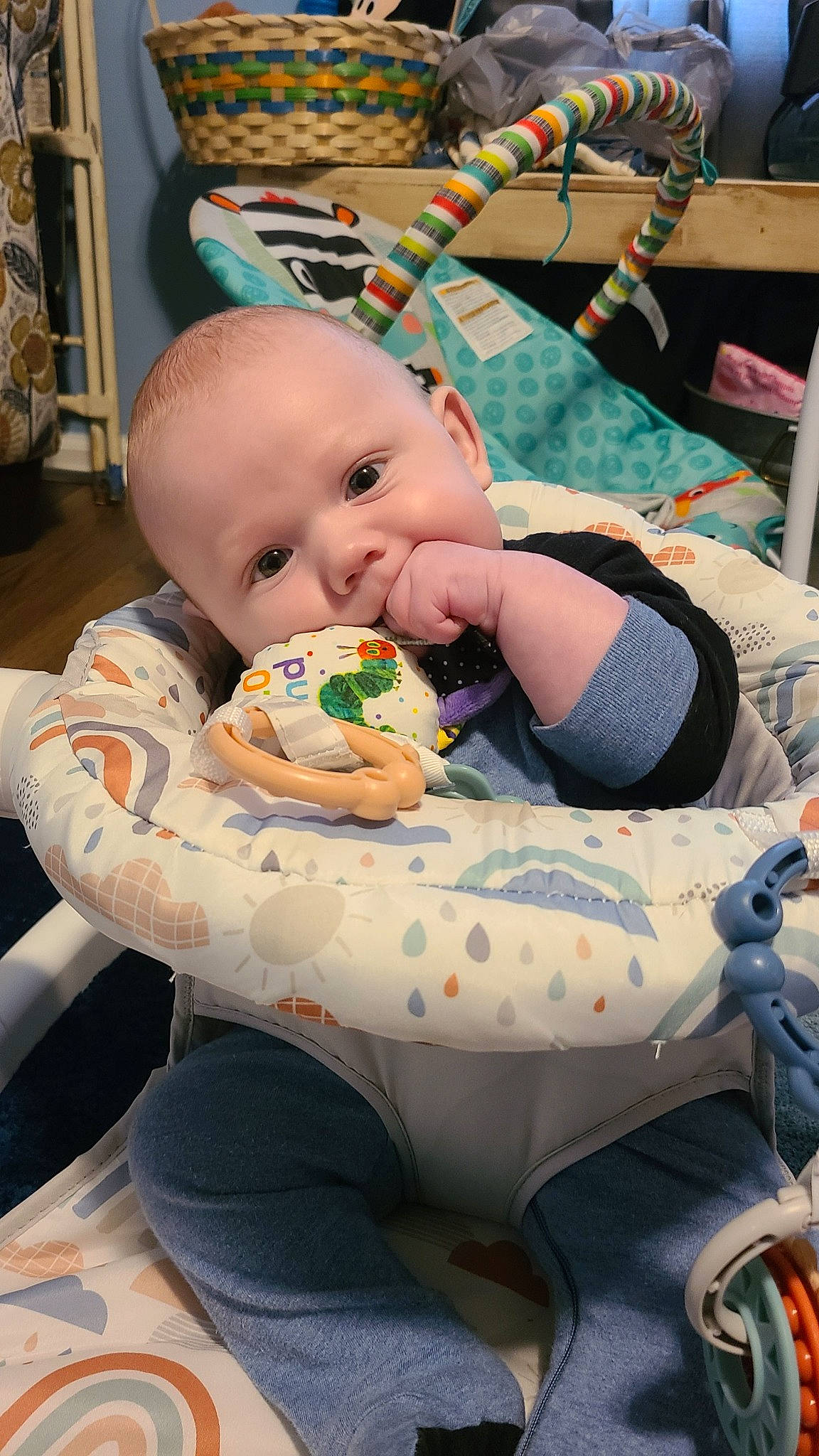 Reid is registered to the contest to win money with this photo: baby, baby_products, baby_toddler_clothing, bib, blue, chair, cheek, child, comfort, event, fun, green, head, human_body, lap, mouth, person, sitting, stuffed_toy, toddler