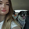 woman, dog, car_interior, selfie, smiling_dog, happy, long_hair, white_shirt, seat, pet, animal, human, portrait, travel, backseat, daylight, expression, cute, leash, harness